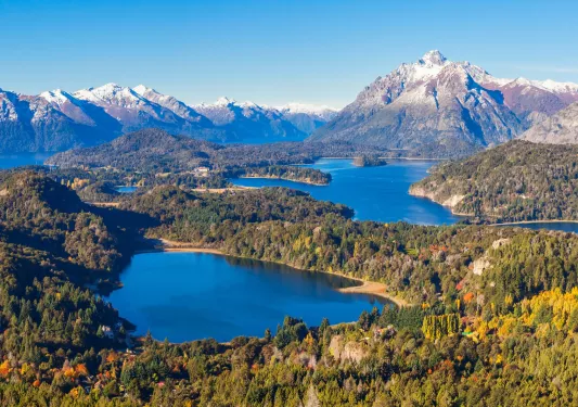 Multiple lakes surrounded by tall trees and mountains