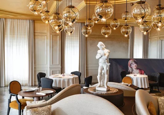 white stone statue in the middle of the dining room