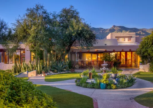 Outdoor garden with a stone walkway and a small fountain in the center