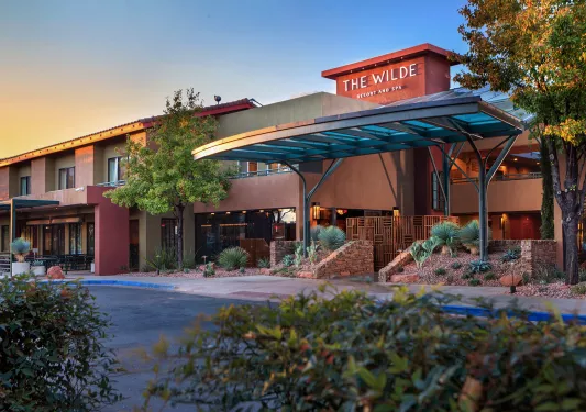 Exterior view of hotel building with stone accents and glass doors