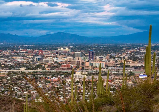 Sky view overlooking a city with large mountains in the distance