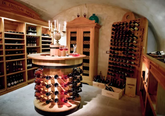 Wine cellar with wooden shelves full of wine bottles