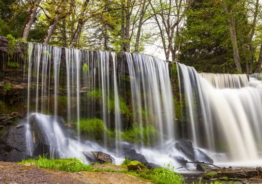 Waterfall over black rocks