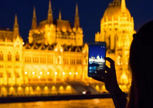 Person taking photo of an illuminated building