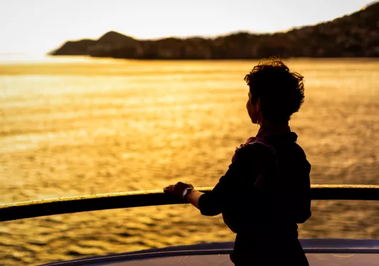 Person on a beach looking into the sunset