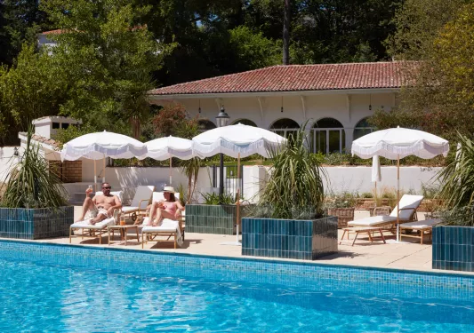 guests lounge by the pool