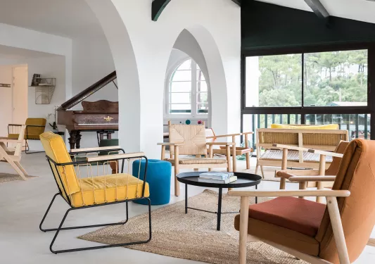 multi color chairs surrounding a coffee table