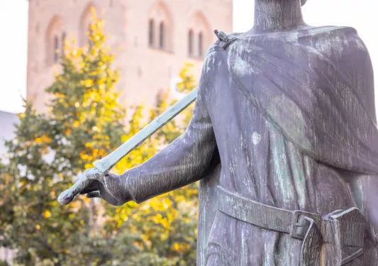 Stone statue with a church building in the background