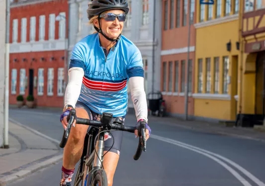 Bikers with sunglasses biking through corridors of a city