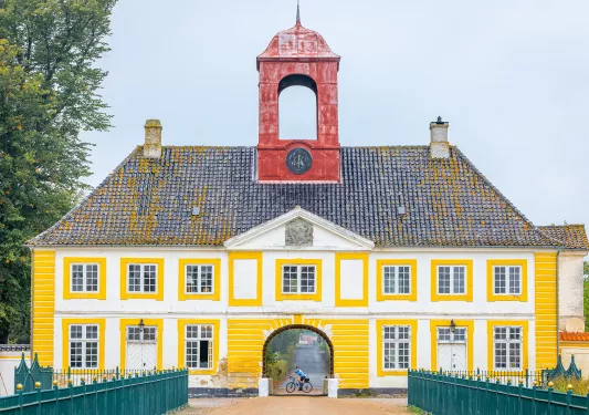 Yellow building with a red clocktower attached to the roof