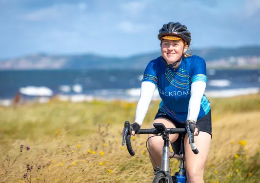 A person biking in a backroads jersey