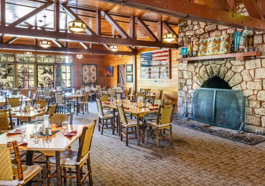 Dining room with a stove fireplace and tables and chairs
