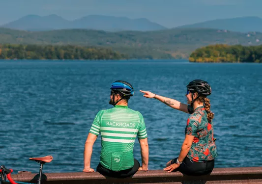 Two people on a dock looking at the water