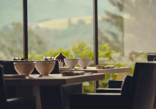 Indoor dining area, with a table and two cups of coffee on the table