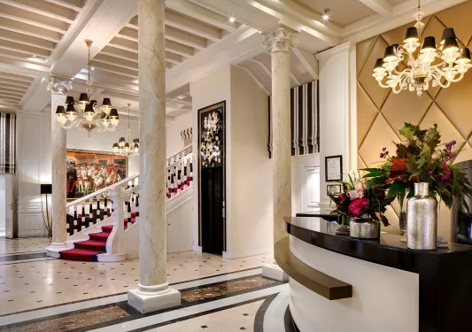 Hotel foyer with a staircase and concierge desk