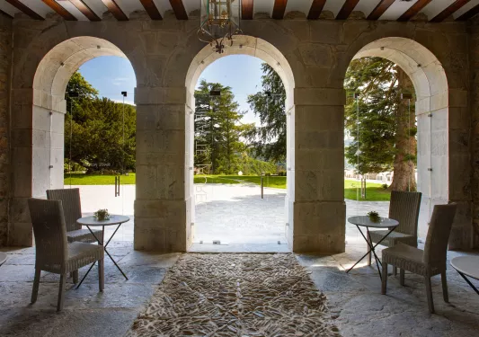 Stone seating area with arches leading to an outdoor courtyard