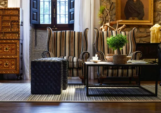 Stone-walled room with two cushioned seats and a coffee table in the center