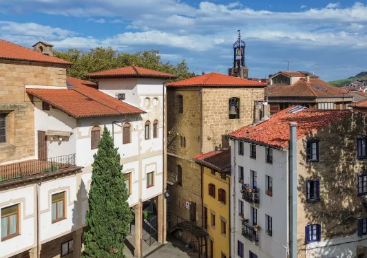 Sky view of 3-story apartment buildings in a small, rustic town