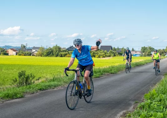 Bikers riding down a path