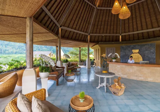 hotel lobby in outdoor patio covered by wooden roof