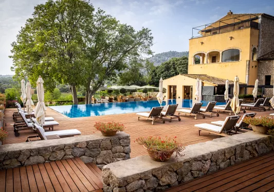 pool and lounge chairs outside of hotel