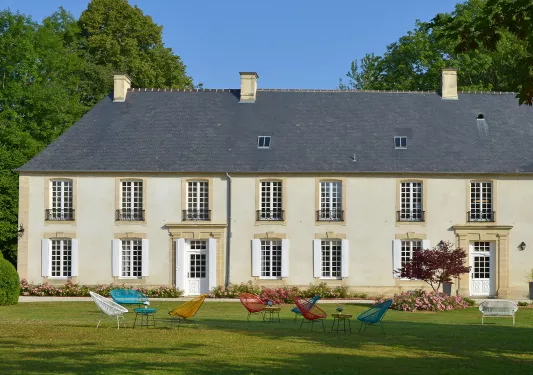 château with colorful chairs on the lawn