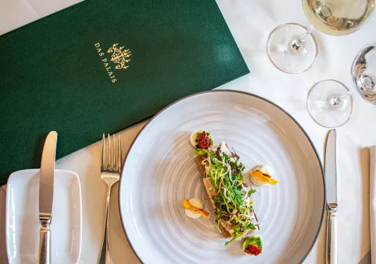 Plate full of fancy sprouts and food, with a green menu on the left