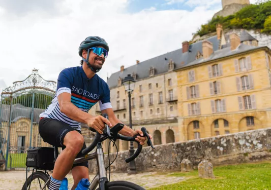 biker riding by large estate