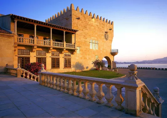 patio with stone railing next to hotel building