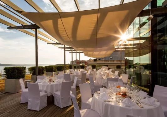 White dining tables on a large patio