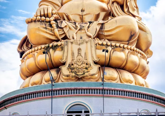 Large gold Buddha statue on top of building