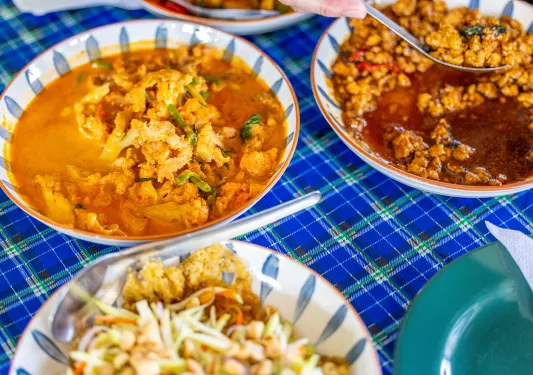 Bowls of food on a blue checkered table