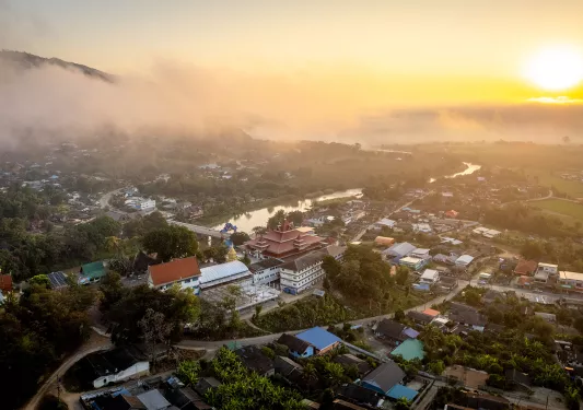 Sky view of small town with large clouds in the sky
