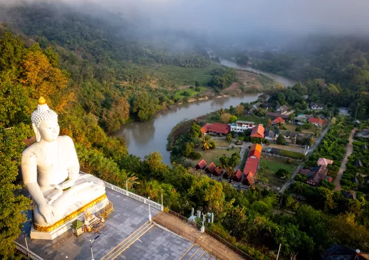 Aerial shot of large statue overlooking town