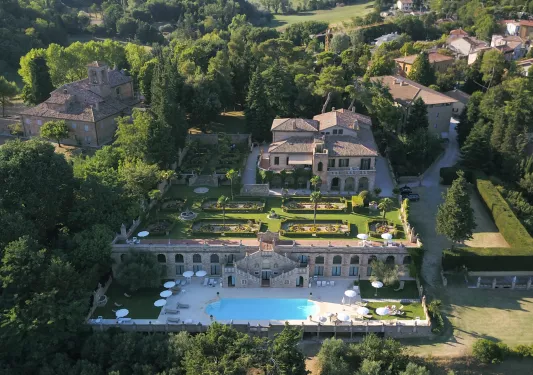 Sky view of stone building, with an outdoor garden and an outdoor pool
