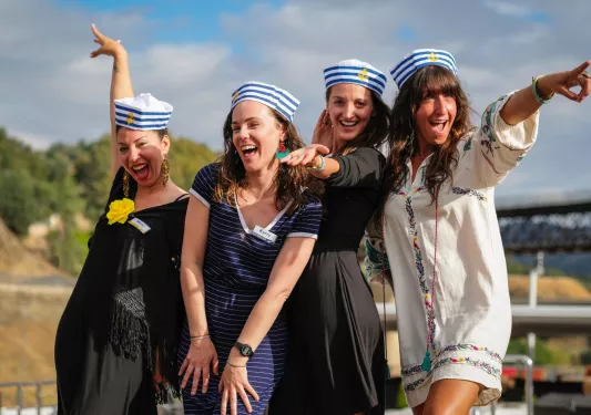 Group of 4 women smiling while wearing sailor hats