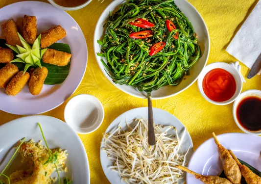 aerial view of overflowing plates on a dinner table