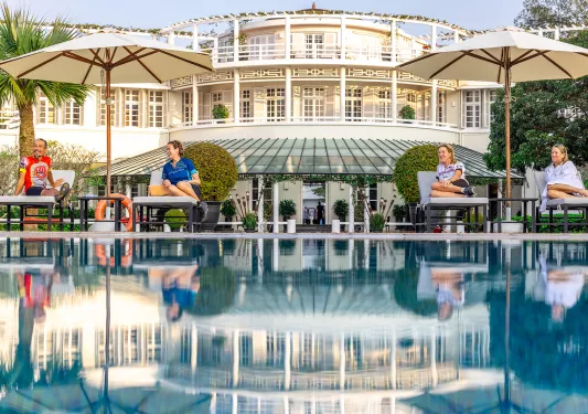 people lounge by a hotel pool