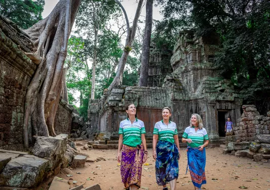 Three people walking through the woods