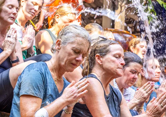 People praying on the steps of a temple