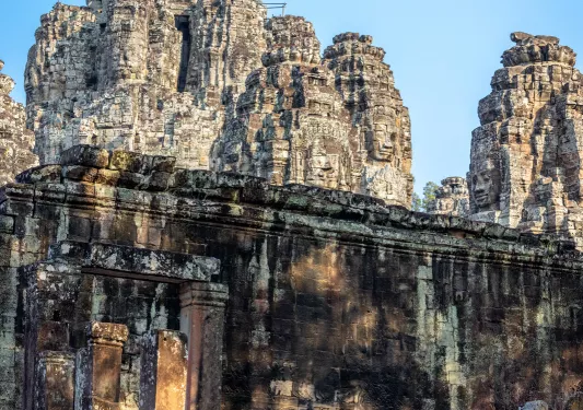 Group of monks walking into ancient temple ruins
