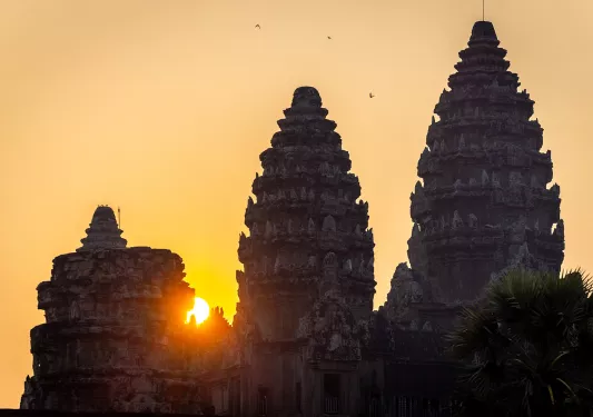 Sun setting behind stone temples