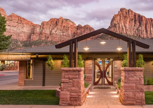 hotel entrance in front of mountains