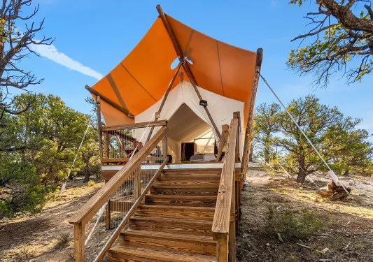 Tent with wooden steps leading the the porch