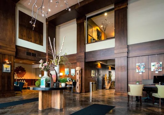 Indoor lobby with a wooden table and vase centerpiece