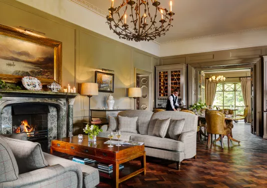 grand living room with fireplace and chandelier