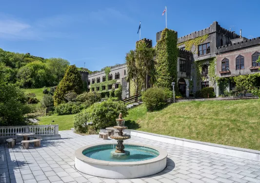 Outdoor courtyard with a circular fountain in the middle of a stone walway