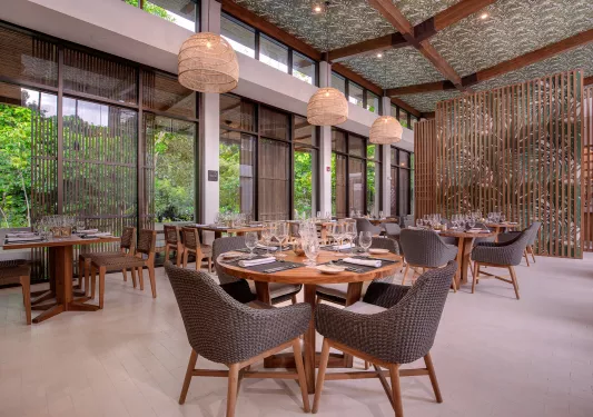 Indoor dining hall with glasses of wine on each table