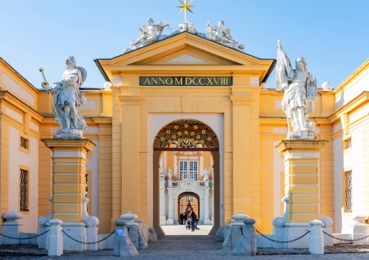 Historic castle with carved statues on a pillar