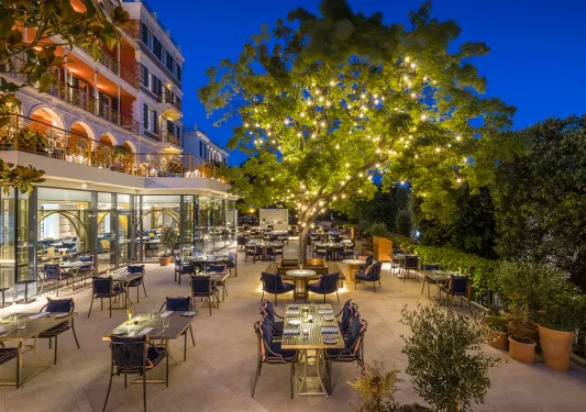 outdoor dining patio under lit up tree